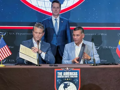U.S. Defense Secretary Pete Hegseth and Colombian Defense Minister Jorge Eduardo Mora sign documents to welcome Colombia into a military-led counter-narcotics coalition of Latin American nations during a signing ceremony in Panama City, Panama, August 12, 2026. Picture taken with a mobile phone. REUTERS/Phil Stewart