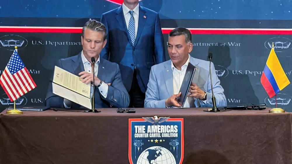 U.S. Defense Secretary Pete Hegseth and Colombian Defense Minister Jorge Eduardo Mora sign documents to welcome Colombia into a military-led counter-narcotics coalition of Latin American nations during a signing ceremony in Panama City, Panama, August 12, 2026. Picture taken with a mobile phone. REUTERS/Phil Stewart