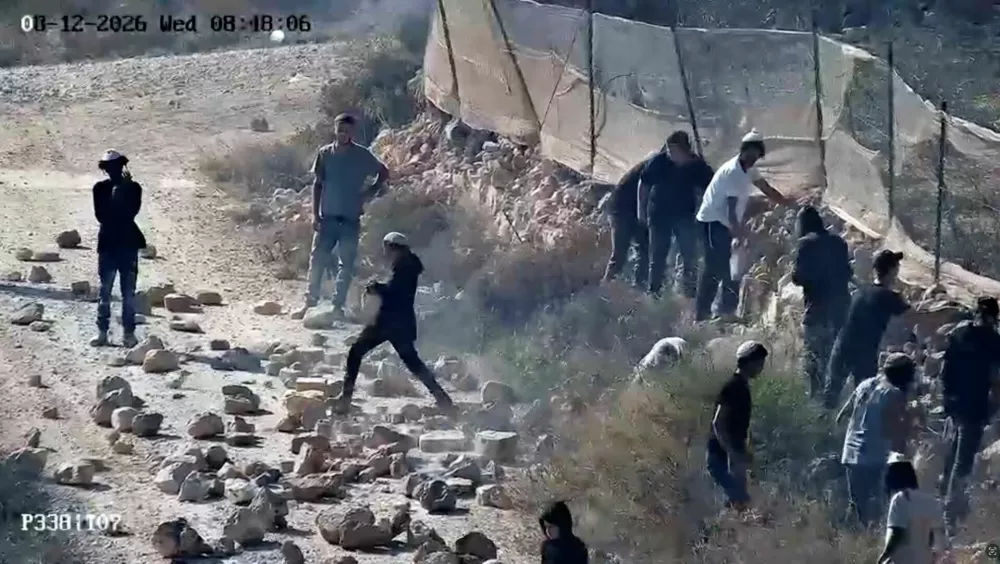CCTV footage shows, as witnesses say, Jewish settlers throwing rocks on the road in Qusra, in the Israeli-occupied West Bank, August 12, 2026 in this screengrab taken from a handout video. Video obtained by Reuters /Handout via REUTERS  THIS IMAGE HAS BEEN SUPPLIED BY A THIRD PARTY. NO RESALES. NO ARCHIVES. VERIFICATION- -Road layout, buildings and terrain matched satellite and archive imagery -Date confirmed from timestamp on the CCTV and sources telling Reuters