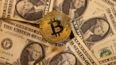 FILE PHOTO: A representation of virtual cryptocurrency Bitcoin is placed on U.S. Dollar banknotes in this illustration taken November 28, 2021. REUTERS/Dado Ruvic/Illustration/File Photo