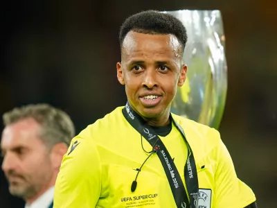 Referee Omar Artan, right, smiles at the end of the UEFA Super Cup soccer match between Paris Saint-Germain and Aston Villa in Salzburg, Austria, Wednesday, Aug.12, 2026. (AP Photo/Darko Bandic)