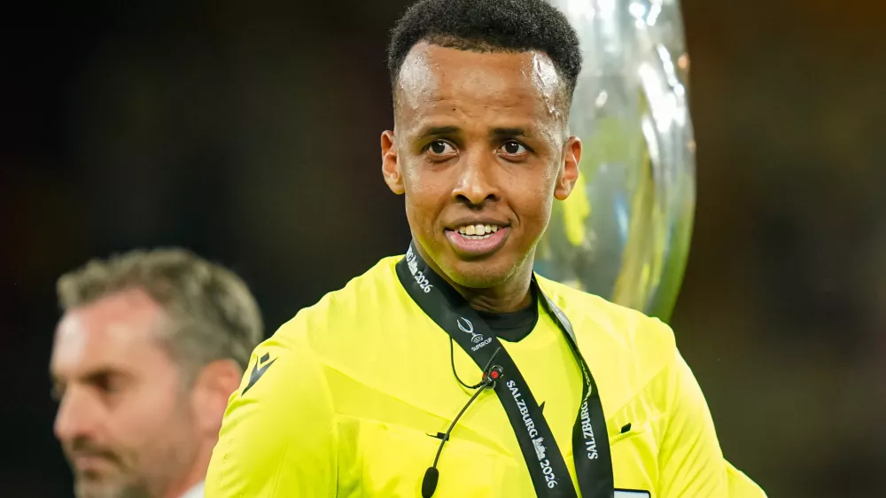 Referee Omar Artan, right, smiles at the end of the UEFA Super Cup soccer match between Paris Saint-Germain and Aston Villa in Salzburg, Austria, Wednesday, Aug.12, 2026. (AP Photo/Darko Bandic)