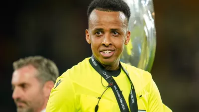 Referee Omar Artan, right, smiles at the end of the UEFA Super Cup soccer match between Paris Saint-Germain and Aston Villa in Salzburg, Austria, Wednesday, Aug.12, 2026. (AP Photo/Darko Bandic)