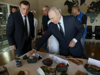 Russian President Vladimir Putin checks products during his visit to the Yasny fish processing complex on the Southern Kuril Island of Iturup, in the far eastern Sakhalin Region, Russia, August 13, 2026. Sputnik/Gavriil Grigorov/Pool via REUTERS ATTENTION EDITORS - THIS IMAGE WAS PROVIDED BY A THIRD PARTY.
