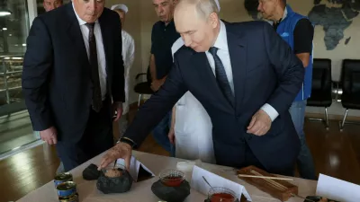 Russian President Vladimir Putin checks products during his visit to the Yasny fish processing complex on the Southern Kuril Island of Iturup, in the far eastern Sakhalin Region, Russia, August 13, 2026. Sputnik/Gavriil Grigorov/Pool via REUTERS ATTENTION EDITORS - THIS IMAGE WAS PROVIDED BY A THIRD PARTY.