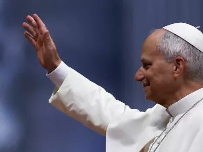 Pope Leo greets the faithful as he arrives to hold the weekly general audience in St. Peter's Basilica at the Vatican, August 12, 2026. REUTERS/Guglielmo Mangiapane