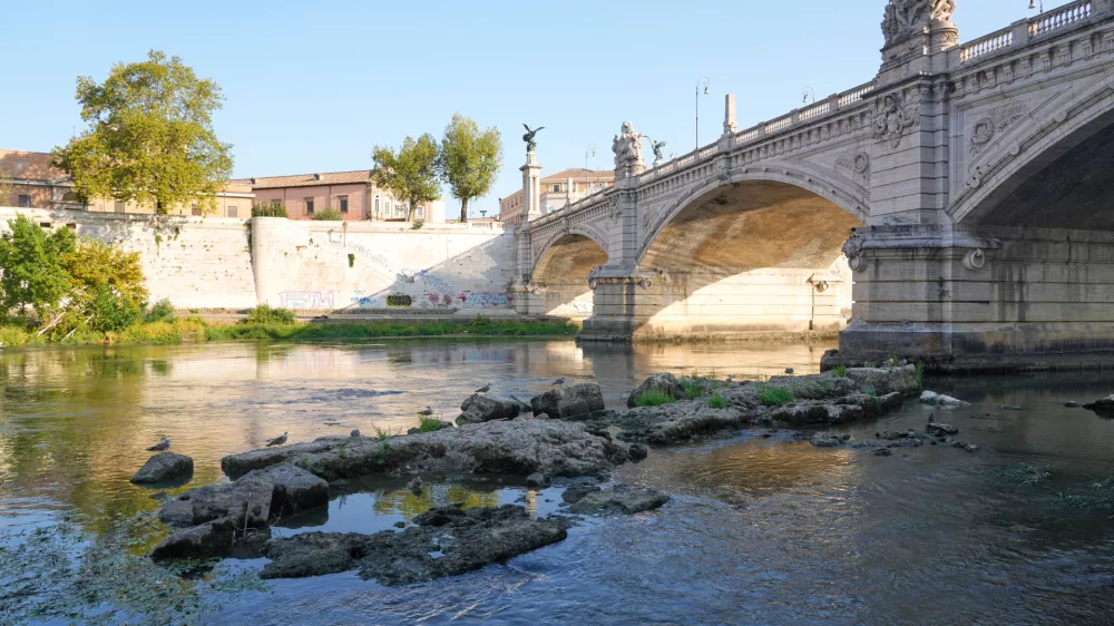 The ruins of the ancient Roman Neronian bridge, emerge from the riverbed of the Tiber river due to drought, in Rome, Thursday, Aug. 13, 2026. (AP Photo/Gregorio Borgia)