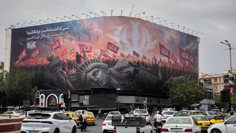 A billboard depicting a fallen Statue of Liberty and crowds carrying Iranian and Shiite flags overlooks Revolution Square as traffic drives by in Tehran, Iran, Monday, Aug. 3, 2026. (AP Photo/Vahid Salemi)