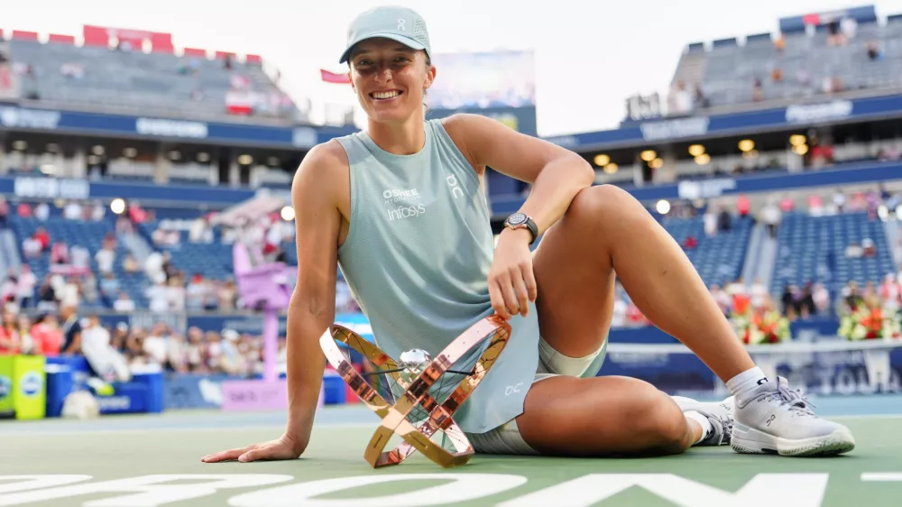 Poland's Iga Swiatek poses with her trophy after defeating Kazakhstan's Elena Rybakina in a National Bank Open final tennis match, in Toronto, Thursday, Aug. 13, 2026. (Chris Young/The Canadian Press via AP)