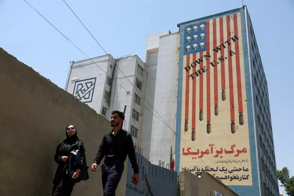 People walk near an anti-U.S. mural in Tehran, Iran, June 28, 2026. Majid Asgaripour/WANA (West Asia News Agency) via REUTERS ATTENTION EDITORS - THIS PICTURE WAS PROVIDED BY A THIRD PARTY. ATTENTION EDITORS - THIS PICTURE WAS PROVIDED BY A THIRD PARTY. ISRAEL OUT. NO COMMERCIAL OR EDITORIAL SALES IN ISRAEL. NO ACCESS FOR ISRAELI MEDIA. NO USE BBC PERSIAN. NO USE VOA PERSIAN. NO USE MANOTO. NO USE IRAN INTERNATIONAL. NO USE RADIO FARDA. DIGITAL: NO USE BBC PERSIAN. NO USE VOA PERSIAN. NO USE MANOTO. NO USE IRAN INTERNATIONAL. NO USE RADIO FARDA.