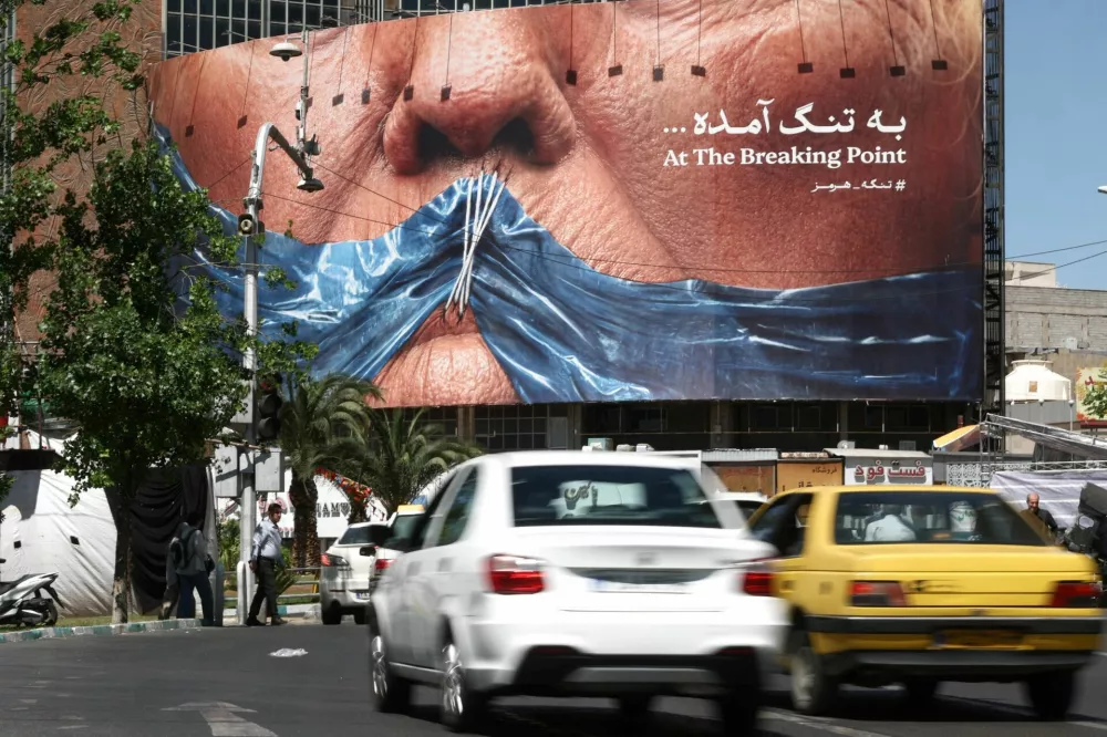 People drive past an anti-U.S. billboard depicting U.S. President Donald Trump and the Strait of Hormuz, in Tehran, Iran, May 26, 2026. Majid Asgaripour/WANA (West Asia News Agency) via REUTERS ATTENTION EDITORS - THIS PICTURE WAS PROVIDED BY A THIRD PARTY