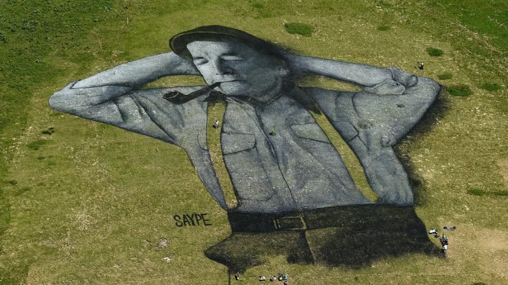 A painting, created by French artist Saype and said to be the world's largest biodegradable painting, is seen on the Chaux-de-Mont ski slope above the Alp resort of Leysin on August 4, 2016. The 100 meter long and 100 meter large painting is made with flour, linseed oil, water and biodegradable natural pigments.,Image: 296151457, License: Rights-managed, Restrictions: RESTRICTED TO EDITORIAL USE - MANDATORY MENTION OF THE ARTIST UPON PUBLICATION - TO ILLUSTRATE THE EVENT AS SPECIFIED IN THE CAPTION, Model Release: no 