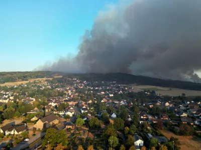 Thick smoke drifts over the Gey district from a forest fire in H&uuml;rtgenwald, Germany, Friday, Aug. 14, 2026. (Federico Gambarini/dpa via AP)
