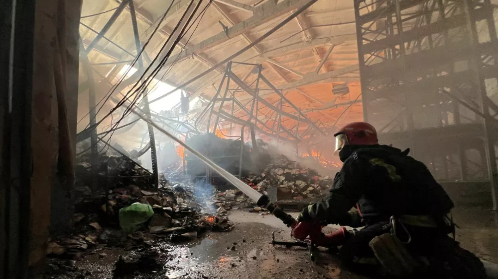 FILE PHOTO: A firefighter works at the site of a book warehouse hit by a Russian drone strike, amid Russia's attack on Ukraine, in Kharkiv, Ukraine, August 1, 2026. Picture taken with a mobile phone. REUTERS/Volodymyr Pavlov/File Photo