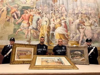 Carabinieri officers pose with three paintings by Paul Cezanne, Henri Matisse and Pierre-Auguste Renoir recovered after they were stolen from the Magnani Rocca Foundation in Mamiano, Italy, in this handout image released on August 14, 2026. Carabinieri/Handout via REUTERS THIS IMAGE HAS BEEN SUPPLIED BY A THIRD PARTY.