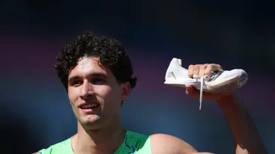 Athletics - European Athletics Championships - Alexander Stadium, Birmingham, Britain - August 12, 2026 Second place Slovenia's Matic Ian Gucek poses with his spike after the men's 400m hurdles semi final 3 REUTERS/Andrew Boyers