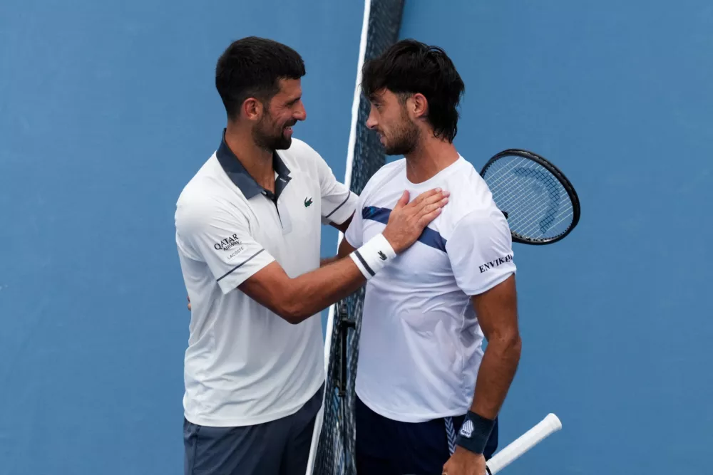 Aug 15, 2026; Mason, OH, USA; Thiago Agust&iacute;n Tirante (ARG) meets with Novak Djokovic (SRB) after their match during the Cincinnati Open at Lindner Family Tennis Center. Mandatory Credit: Aaron Doster-Imagn Images