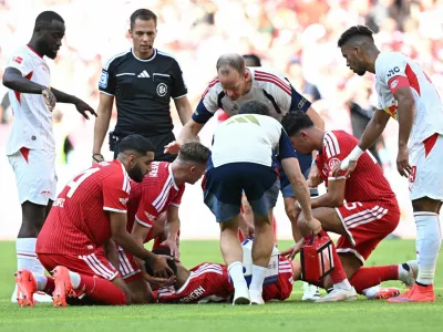 Soccer Football - Pre Season Friendly - Bayern Munich v RB Leipzig - Allianz Arena, Munich, Germany - August 15, 2026 Bayern Munich's Jamal Musiala receives medical attention after sustaining an injury as Ismael Saibari looks on REUTERS/Angelika Warmuth