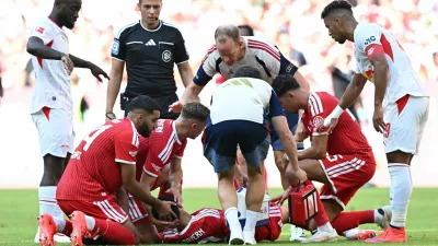 Soccer Football - Pre Season Friendly - Bayern Munich v RB Leipzig - Allianz Arena, Munich, Germany - August 15, 2026 Bayern Munich's Jamal Musiala receives medical attention after sustaining an injury as Ismael Saibari looks on REUTERS/Angelika Warmuth