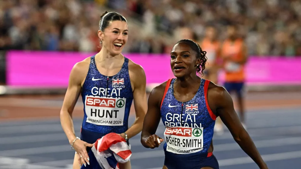 Athletics - European Athletics Championships - Alexander Stadium, Birmingham, Britain - August 16, 2026 Great Britain's Amy Hunt and Dina Asher-Smith celebrate winning the gold medal in the 4x100m mixed relay final REUTERS/Dylan Martinez