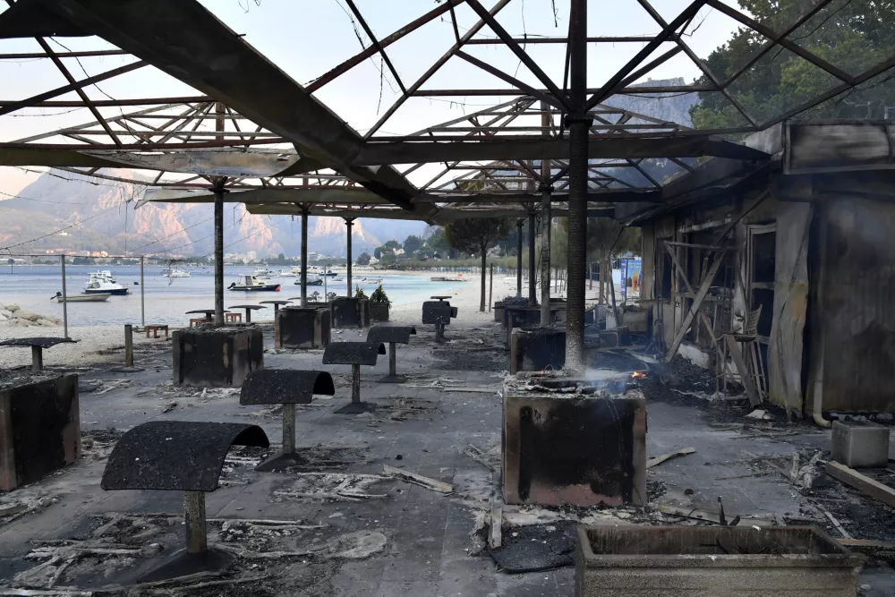 A view of a beach bar in the aftermath of a wildfire on the Adriatic coast near Omis, southern Croatia, Friday, Aug. 14, 2026. (AP Photo/Josko Ponos)