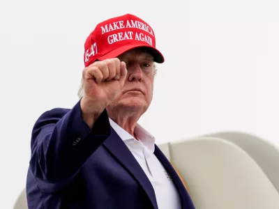 President Donald Trump gestures while boarding Air Force One at Morristown Airport, Sunday, Aug. 16, 2026, in Morristown, N.J. (AP Photo/Julia Demaree Nikhinson)