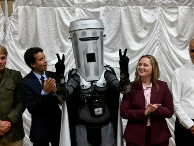 Count Binface gestures while standing with other candidates after Reform UK party leader Nigel Farage was declared the winner for the Clacton by-election, triggered by the resignation of Farage, in Essex, Britain, August 14, 2026. REUTERS/Jack Taylor   TPX IMAGES OF THE DAY    REFILE - UPDATING GRAMMAR