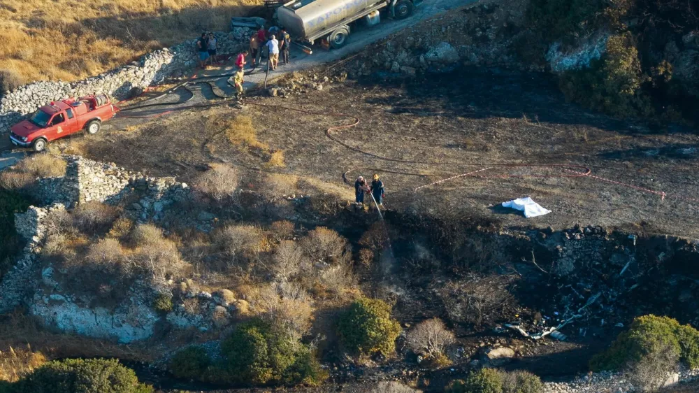 Emergency personnel work near a covered body at the site of a private helicopter crash, on the island of Sifnos, Greece, August 17, 2026. IN TIME NEWS/Handout via REUTERS THIS IMAGE HAS BEEN SUPPLIED BY A THIRD PARTY. NO RESALES. NO ARCHIVES. GREECE OUT. NO EDITORIAL SALES IN GREECE.