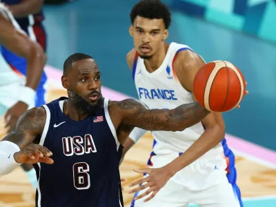 Paris 2024 Olympics - Basketball - Men's Gold Medal Game - France vs United States - Bercy Arena, Paris, France - August 10, 2024. Lebron James of United States in action with Victor Wembanyama of France. REUTERS/Stephanie Lecocq