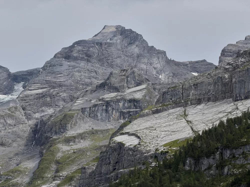 The "Spitze Stei" rock massive with the Bluemlisalphorn peak in the background seen over the Oeschinensee near Kandersteg, Switzerland, Tuesday, Aug. 4, 2026. (AP Photo/Hernan Munoz)
