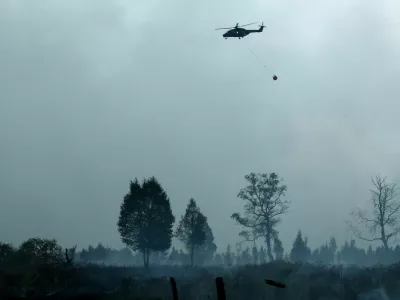 A Belgian Army helicopter flies over the area affected by a wildfire, near Waimes, in the High Fens (Hautes Fagnes) region, Belgium, August 17, 2026. REUTERS/Yves Herman