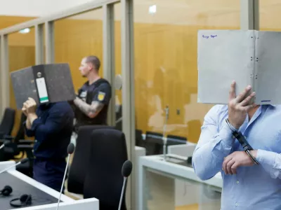 Defendants Daniil B., Vladyslav T. and Yevhen B. cover their faces as they arrive in the courtroom, where the court is expected to conclude the trial against the three Ukrainian nationals suspected of conspiracy to commit arson attacks on behalf of a Russian intelligence service, at the Stuttgart Higher Regional Court (Oberlandesgericht Stuttgart) in Stuttgart, Germany, August 18, 2026. REUTERS/Heiko Becker