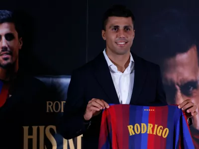 Barcelona's Rodri poses with his jersey during his official presentation at a soccer press conference in Barcelona, Spain, Tuesday, Aug. 18, 2026. (AP Photo/Joan Monfort)