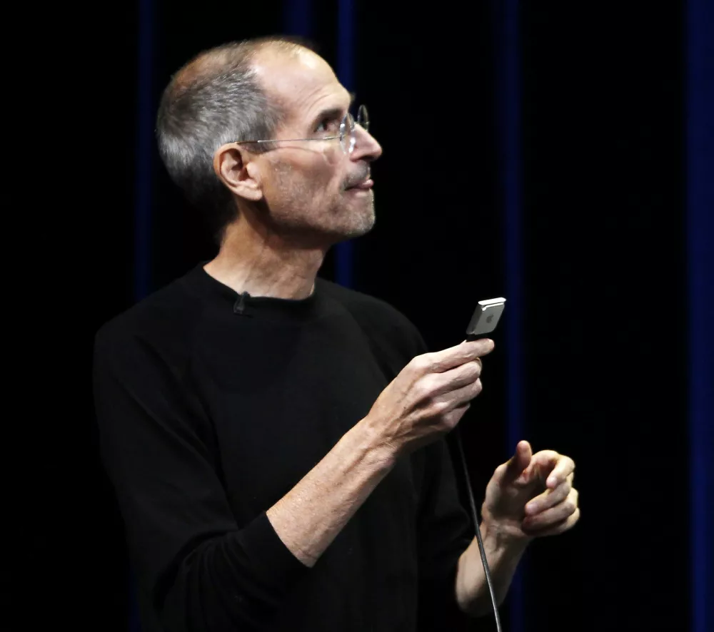 Apple CEO Steve Jobs speaks on stage while holding the new iPod Nano at Apple's music-themed September media event in San Francisco, California in this September 1, 2010 file photo. Jobs said on January 17, 2011 the board has granted him medical leave to concentrate on his health. Apple stock fell as much as 7 percent on the Frankfurt Stock Exchange following the news. REUTERS/Robert Galbraith/Files (UNITED STATES - Tags: BUSINESS HEALTH SCI TECH)