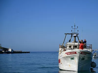 A fishing boat is navigated during its' return to the port of Lampedusa after a day at sea in Lampedusa on July 8, 2026. The fishermen of Lampedusa were long the lifeblood of the Italian island, but they now have to cast their nets amidst the wrecks of migrant boats and fish affected by the warming of the Mediterranean.,Image: 1115199951, License: Rights-managed, Restrictions: TO GO WITH AFP STORY BY Ella IDE, Model Release: no 