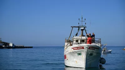 A fishing boat is navigated during its' return to the port of Lampedusa after a day at sea in Lampedusa on July 8, 2026. The fishermen of Lampedusa were long the lifeblood of the Italian island, but they now have to cast their nets amidst the wrecks of migrant boats and fish affected by the warming of the Mediterranean.,Image: 1115199951, License: Rights-managed, Restrictions: TO GO WITH AFP STORY BY Ella IDE, Model Release: no 