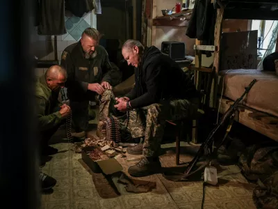 Serhii Krynitskyi, 42, a serviceman of the 24th Separate Mechanized Brigade of the Ukrainian Armed Forces, who spent 346 days at an isolated frontline position in the town of Chasiv Yar, Donetsk region, helps his fellow soldiers load machine gun cartridges on his first day back on duty after recovery, amid Russia's attack on Ukraine, in the frontline city of Kramatorsk in Donetsk region, Ukraine, May 27, 2026. REUTERS/Alina Smutko
