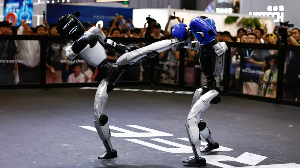 Humanoid robots by Unitree Robotics demonstrate kickboxing during the 2026 World Robot Conference, in Beijing, China August 19, 2026. REUTERS/Tingshu Wang