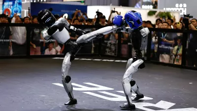 Humanoid robots by Unitree Robotics demonstrate kickboxing during the 2026 World Robot Conference, in Beijing, China August 19, 2026. REUTERS/Tingshu Wang