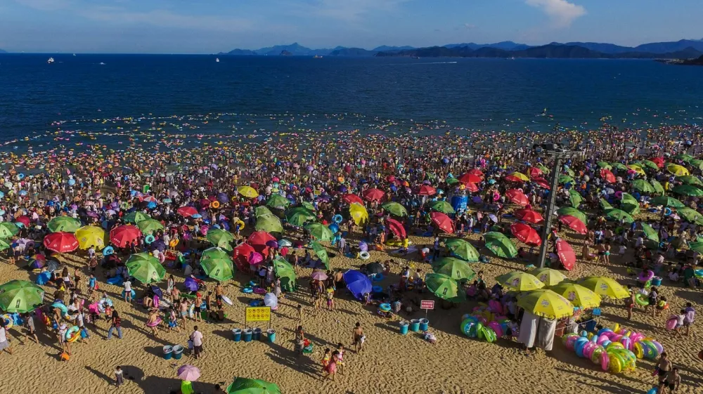SHENZHEN, Aug. 2, 2015 People enjoy themselves at the Dameisha Beach Seashore Park in Shenzhen, south China's Guangdong Province, Aug. 2, 2015. As temperature rises in summer in Shenzhen, many tourists went to the seaside for swimming and sunbath.,Image: 254463175, License: Rights-managed, Restrictions:, Model Release: no 