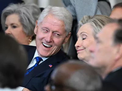 (L-R) Former US President Bill Clinton and former Secretary of State Hillary Clinton listen as President Donald Trump speaks after being sworn in as the 47th President in the US Capitol Rotunda in Washington, DC, on January 20, 2025.  SAUL LOEB/Pool via REUTERS