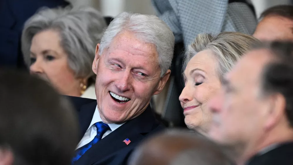 (L-R) Former US President Bill Clinton and former Secretary of State Hillary Clinton listen as President Donald Trump speaks after being sworn in as the 47th President in the US Capitol Rotunda in Washington, DC, on January 20, 2025.  SAUL LOEB/Pool via REUTERS
