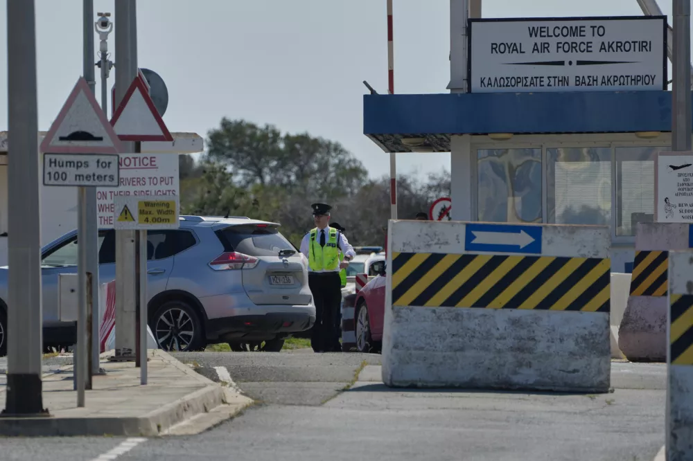 A Force Protection personnel inspects a vehicle at the main gate of the U.K.'s RAF Akrotiri air base after it was hit by a drone strike early morning near Limassol, Cyprus, Monday, March, 2, 2026. (AP Photo/Petros Karadjias)