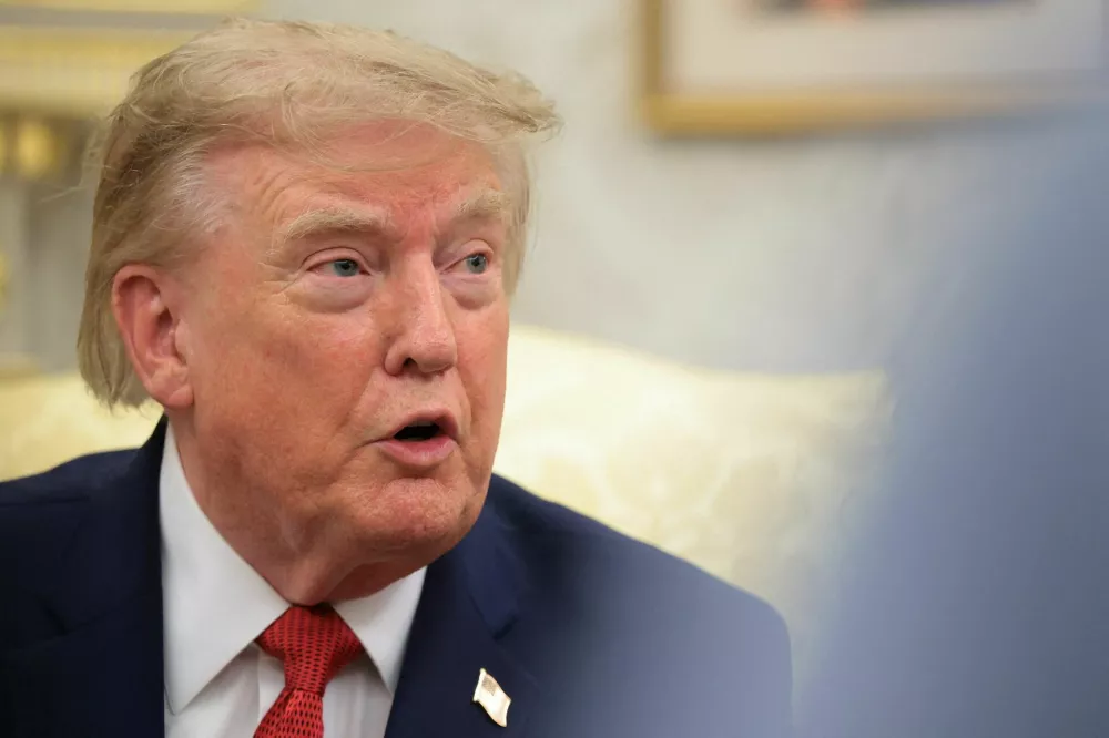 U.S. President Donald Trump speaks as he hosts 16-year-old lifeguard Ryder Williams, who saved a child off the coast of Santa Cruz, California, last month, Nathaniel Rai, the child saved by Williams, and Nathaniel's family members in the Oval Office at the White House in Washington, D.C., U.S., August 17, 2026. REUTERS/Kylie Cooper