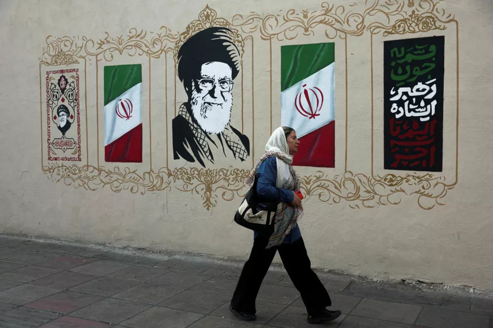 FILE PHOTO: A woman walks by a mural depicting Iran's late Supreme Leader Ayatollah Ali Khamenei, on a street in Tehran, Iran, August 13, 2026. Majid Asgaripour/WANA (West Asia News Agency) via REUTERS ATTENTION EDITORS - THIS PICTURE WAS PROVIDED BY A THIRD PARTY. ISRAEL OUT. NO COMMERCIAL OR EDITORIAL SALES IN ISRAEL. NO ACCESS FOR ISRAELI MEDIA. NO USE BBC PERSIAN. NO USE VOA PERSIAN. NO USE MANOTO. NO USE IRAN INTERNATIONAL. NO USE RADIO FARDA. DIGITAL: NO USE BBC PERSIAN. NO USE VOA PERSIAN. NO USE MANOTO. NO USE IRAN INTERNATIONAL. NO USE RADIO FARDA./File Photo