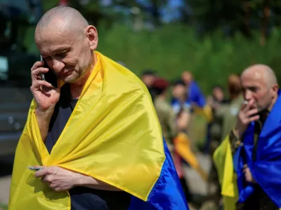 A Ukrainian prisoner of war (POW) reacts while he speaks with relatives via a phone after a swap, amid Russia's attack on Ukraine, at an undisclosed location in Ukraine August 19, 2026. REUTERS/Valentyn Ogirenko