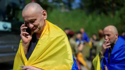 A Ukrainian prisoner of war (POW) reacts while he speaks with relatives via a phone after a swap, amid Russia's attack on Ukraine, at an undisclosed location in Ukraine August 19, 2026. REUTERS/Valentyn Ogirenko