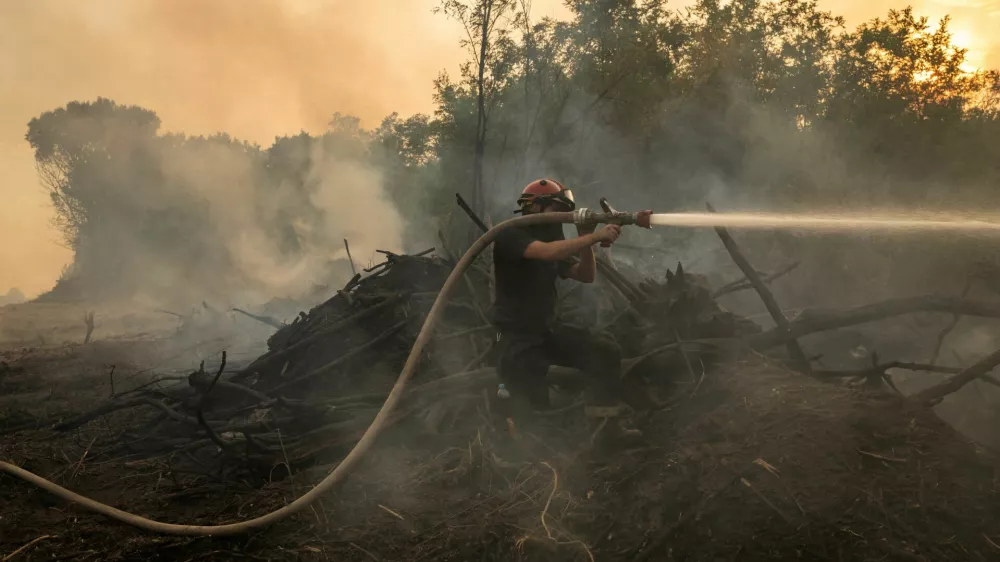 A firefighter battles a wildfire in Deliblatska Pescara, Serbia, August 18, 2026. REUTERS/Marko Djurica   TPX IMAGES OF THE DAY