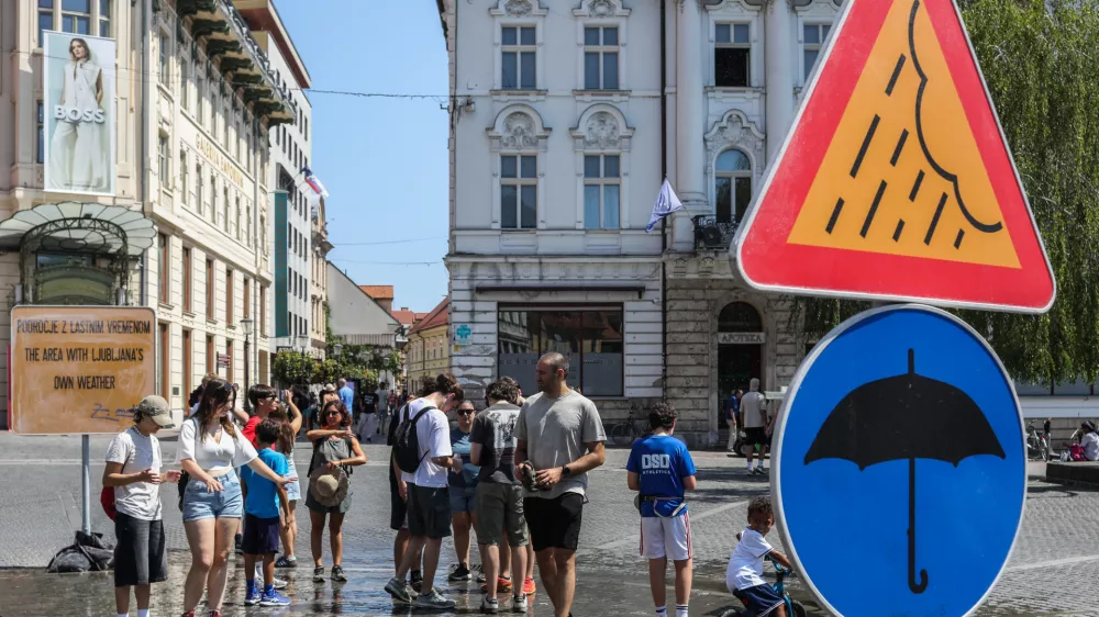 - Turisti i&scaron;čejo osvežitev z vodo na Pre&scaron;ernovem trgu, kjer je in&scaron;talacija Območje z lastnim vremenom. - 03.08.2026. - Vročinski val, Ljubljana.//FOTO: Bojan Velikonja / Foto: Bojan Velikonja