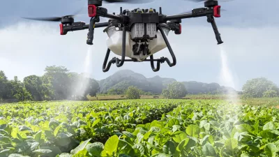 An industrial drone on green field. sprays useful pesticides to increase productivity and destroy harmful insects. increase productivity. Modern technologies in agriculture